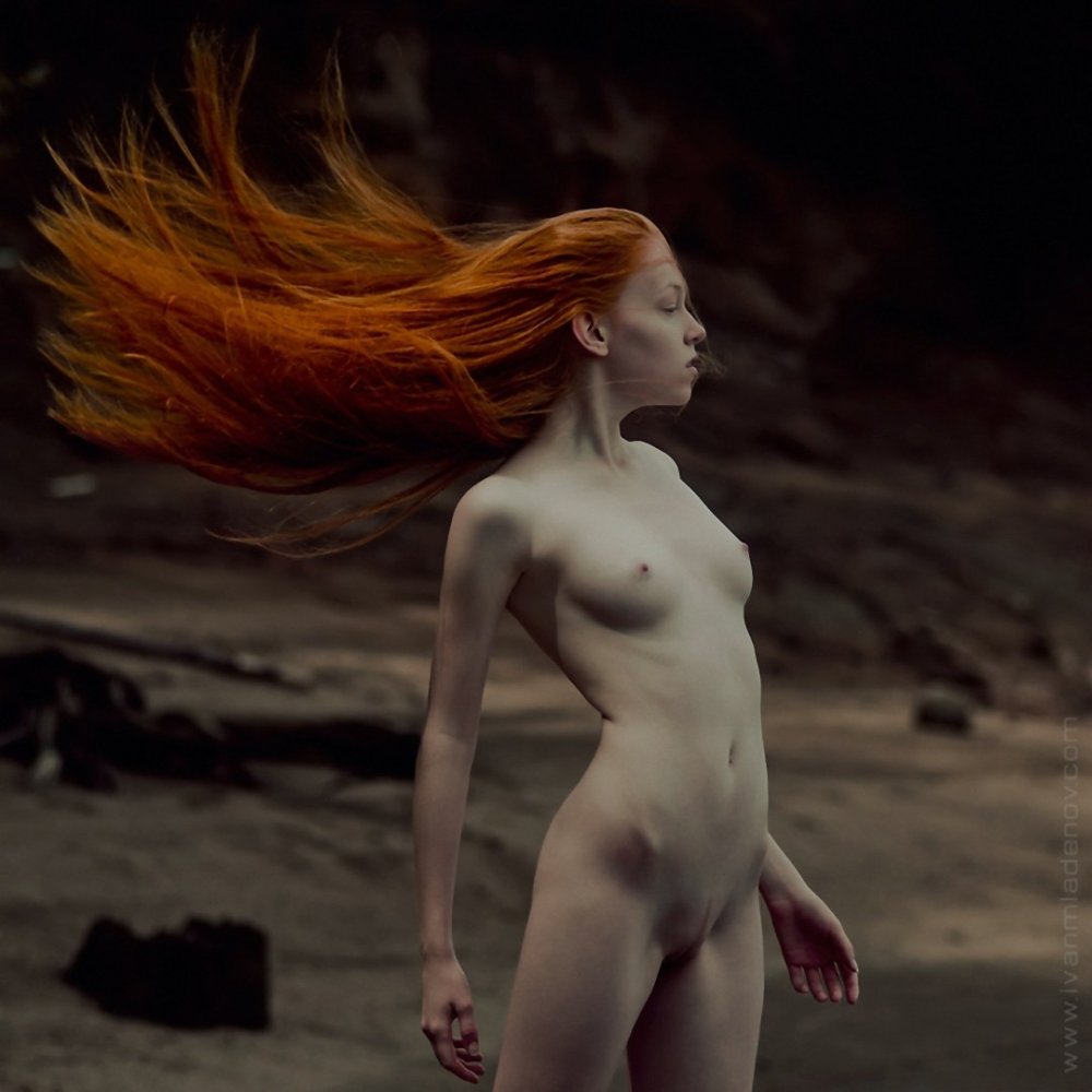 Red -haired girl with long hair nude