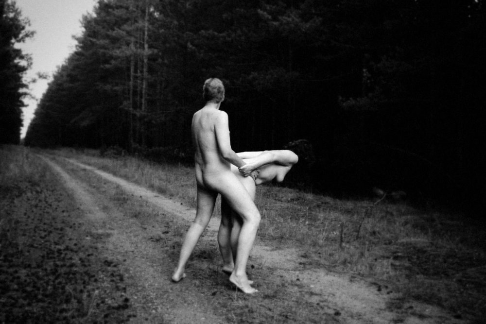 Naked men and women in the forest