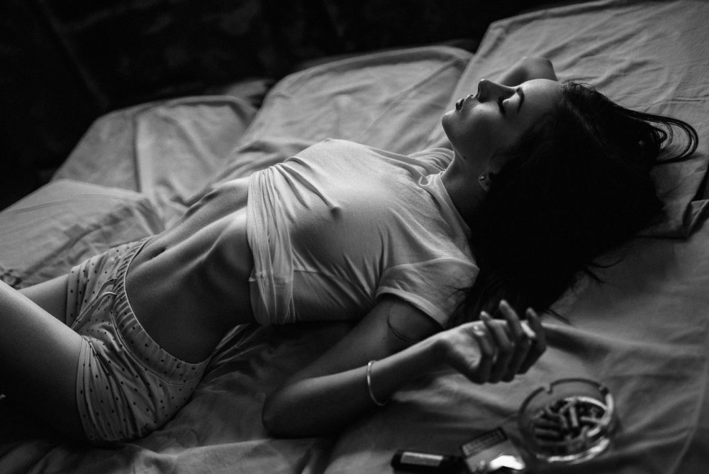 The girl lies with a cigarette