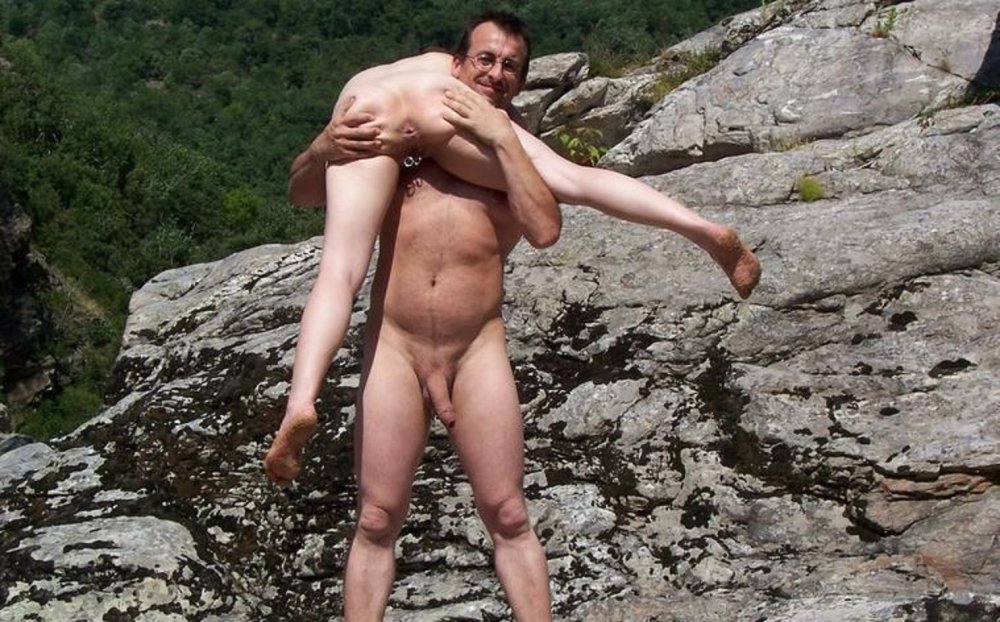 Nudist is held in their arms