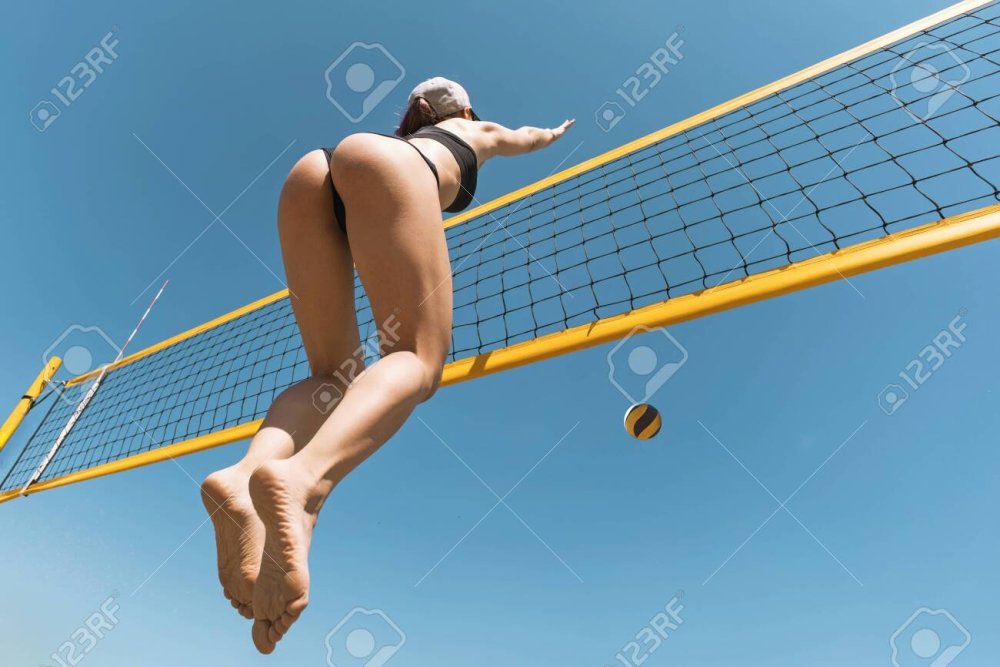Naked women athletes play volleyball