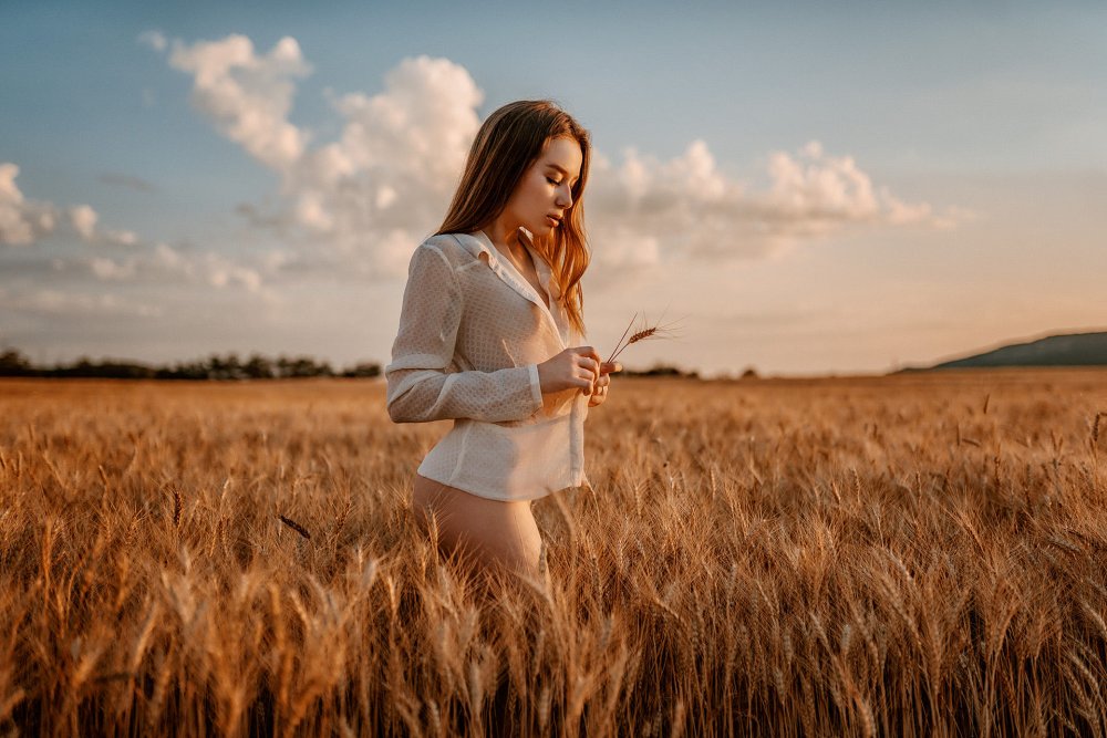 Girl on the field in the mountains
