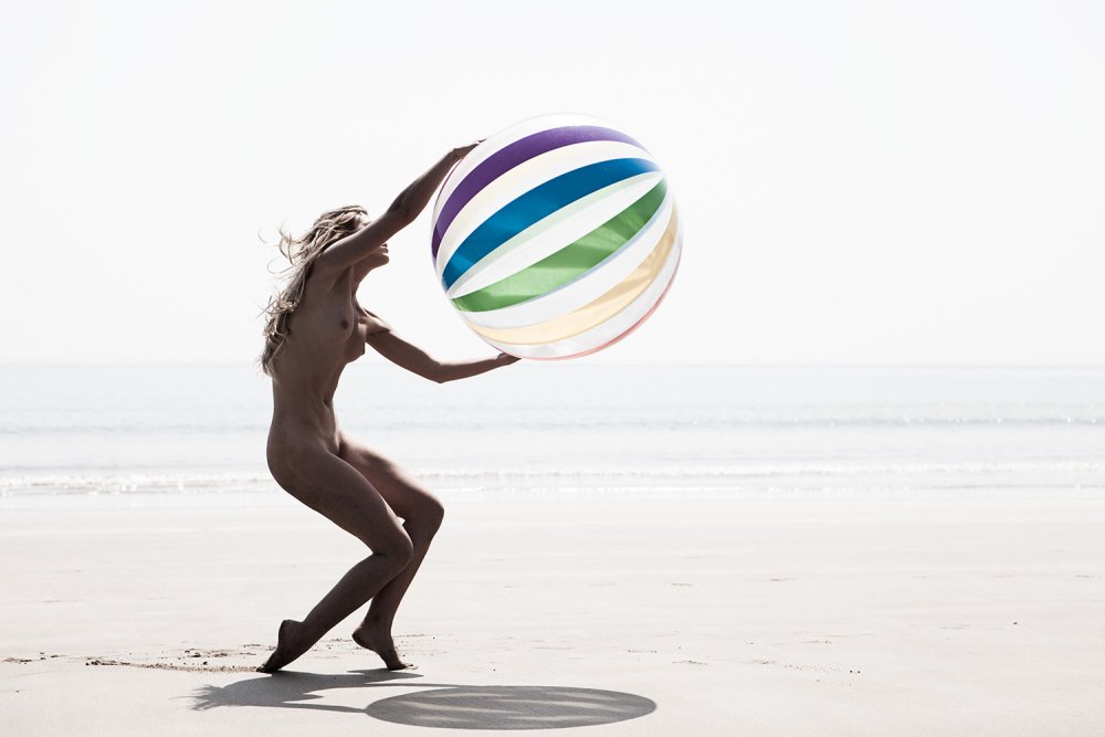 Naked on the beach with a ball