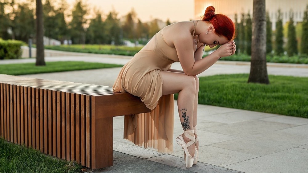 Sultry Redhead Posing on a Bench