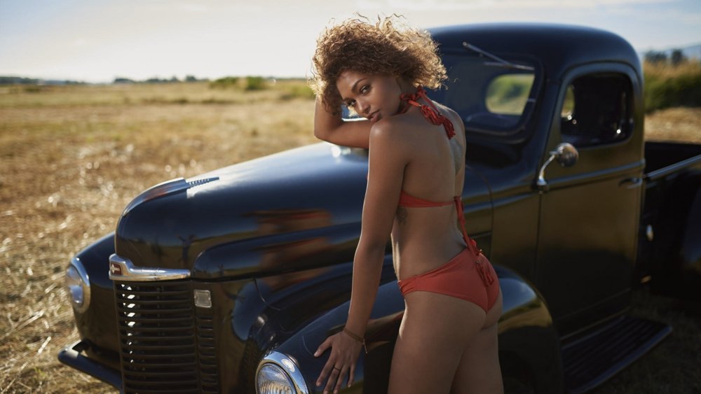 A dark -skinned girl on a red convertible crashes into a truck film