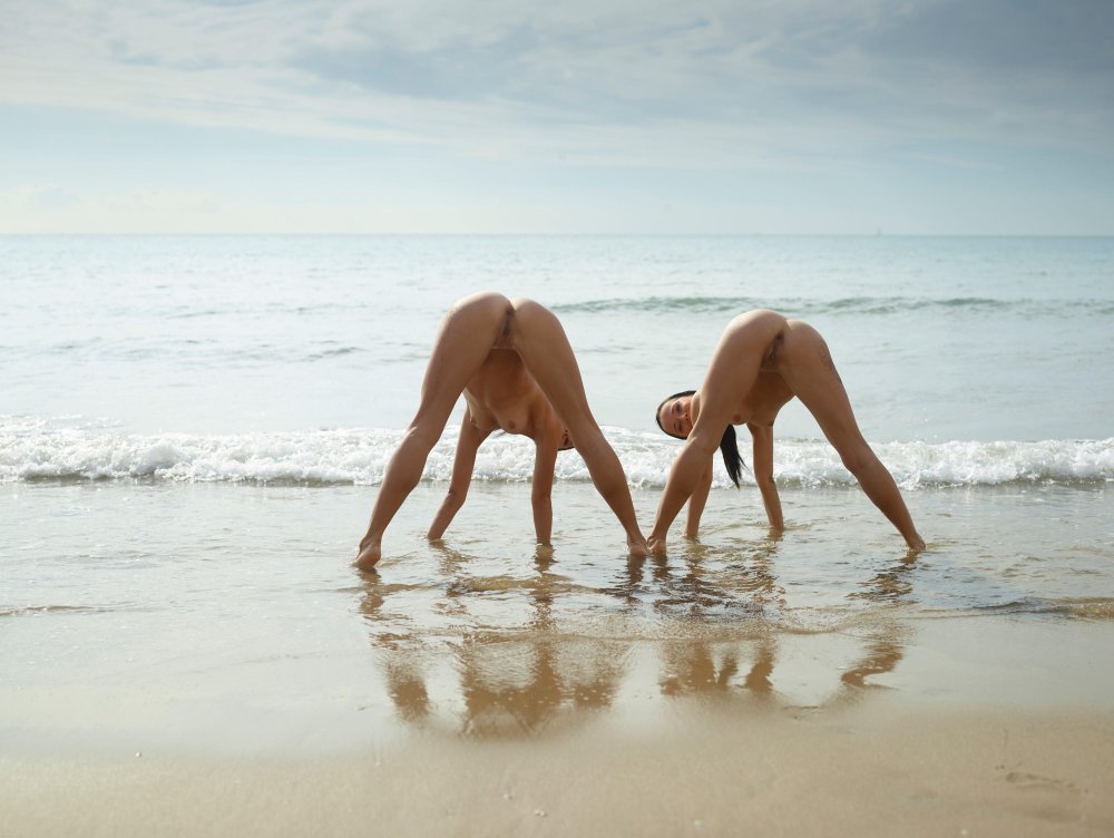 Naked yoga on the seashore