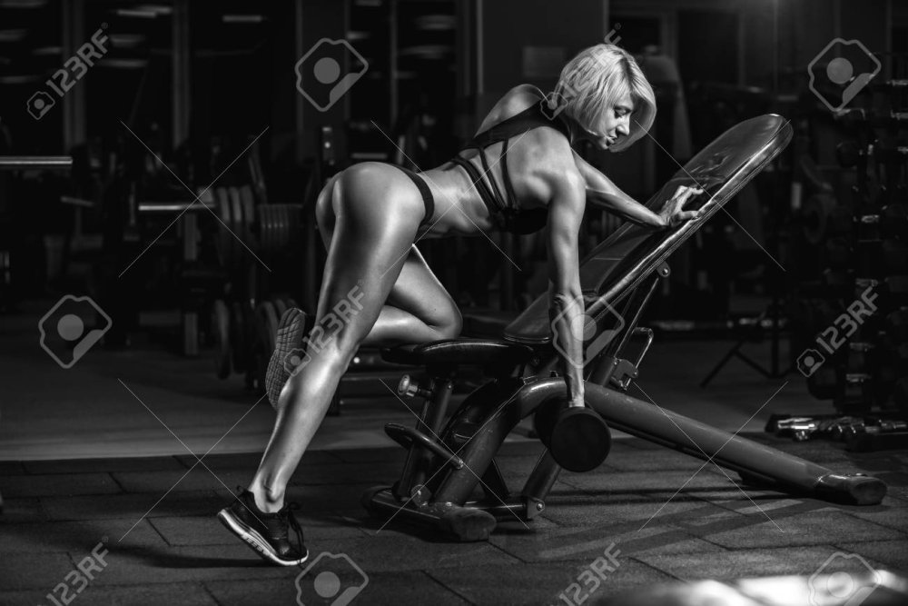 Naked woman does strength exercise