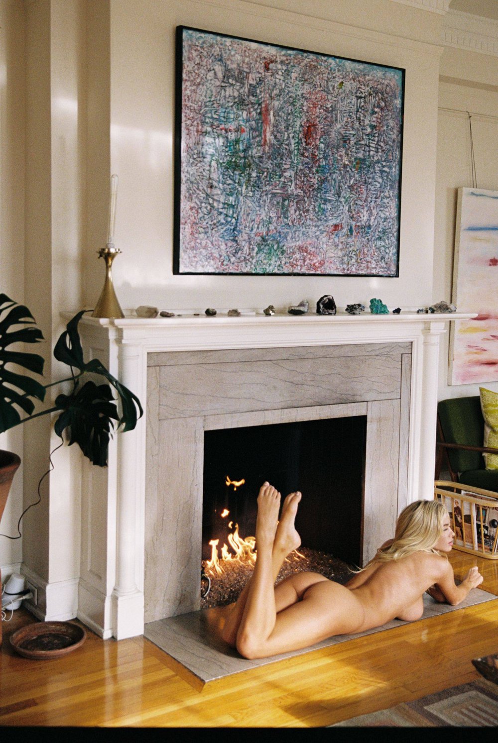 Naked blonde near the fireplace