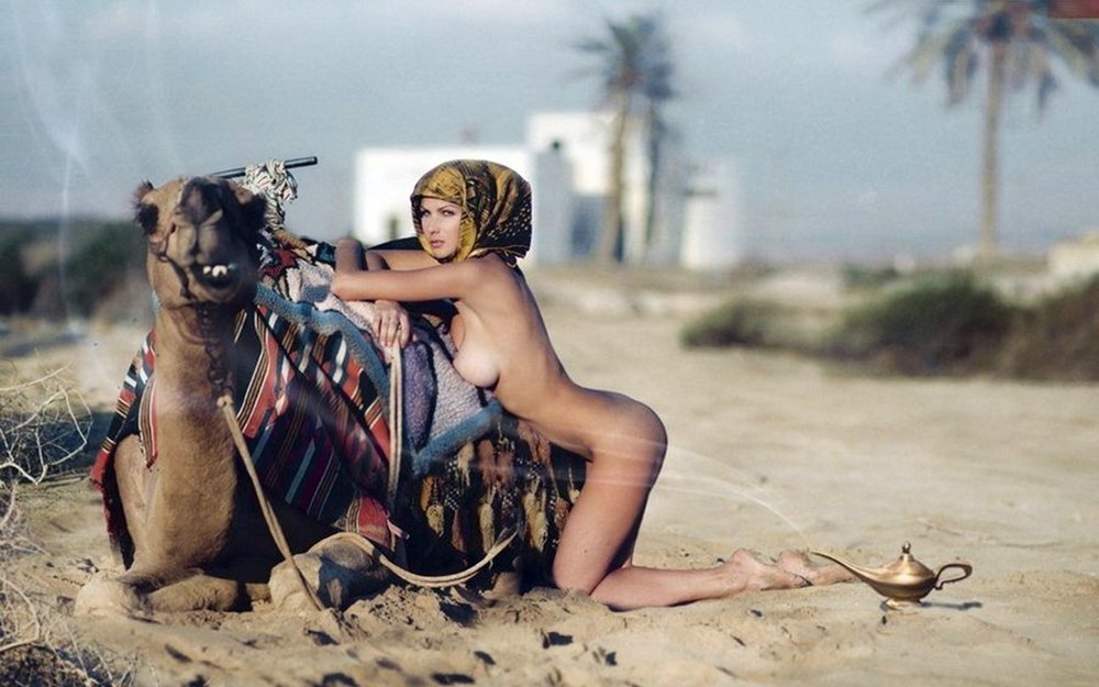 Naked with a camel in the desert
