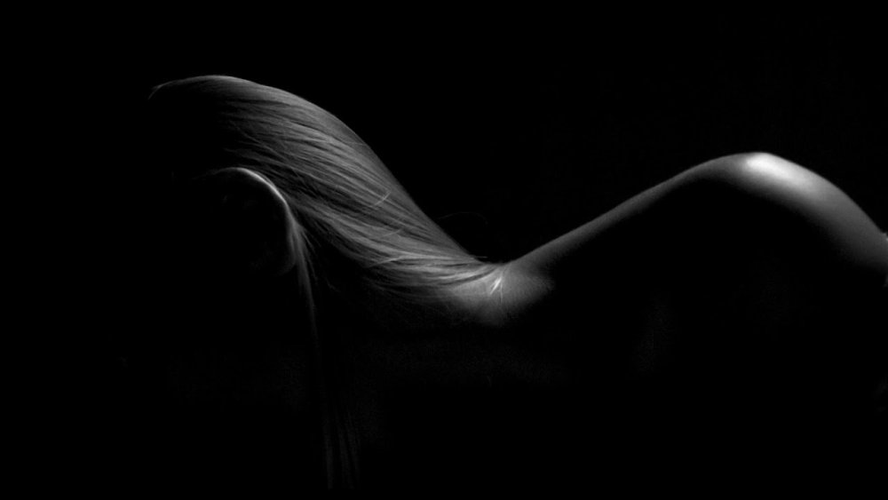 Women's body on a black background