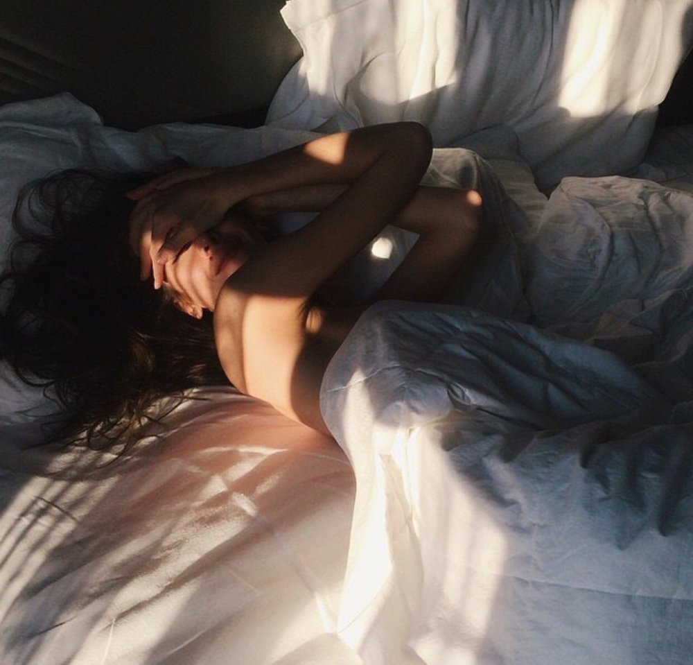 Brunette girl in bed