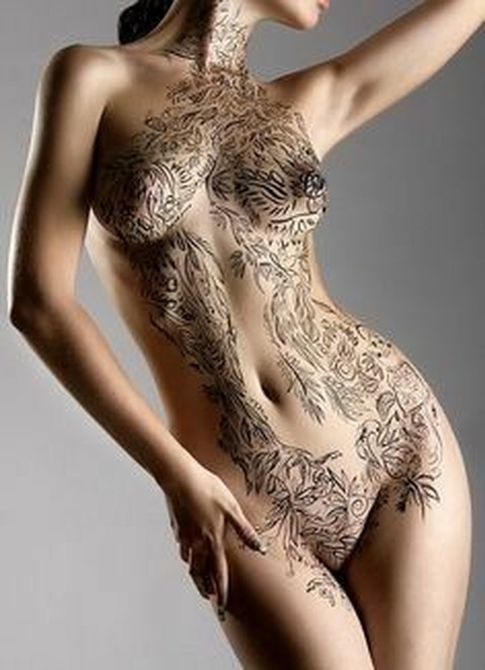 Naked female body in tattoos