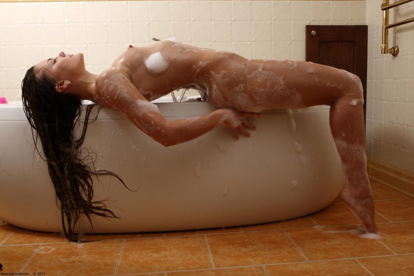 Woman bathes in the bath naked