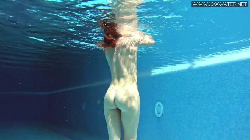 The girl bathes naked underwater in