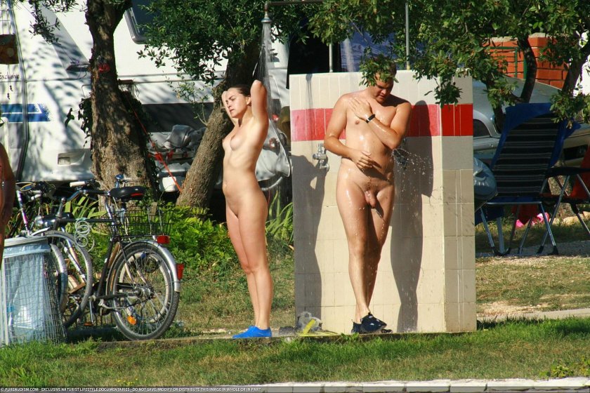 Naked women lie on the beach