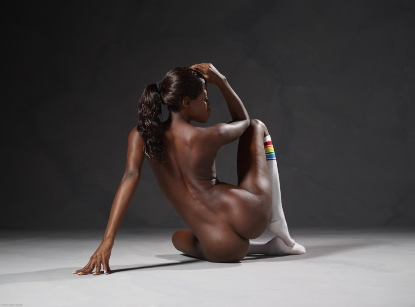 A naked woman lies on her back