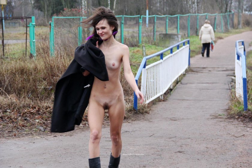 Naked woman walks along the street