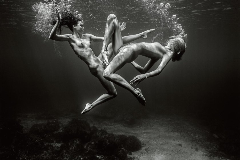 Naked women and a guy in water