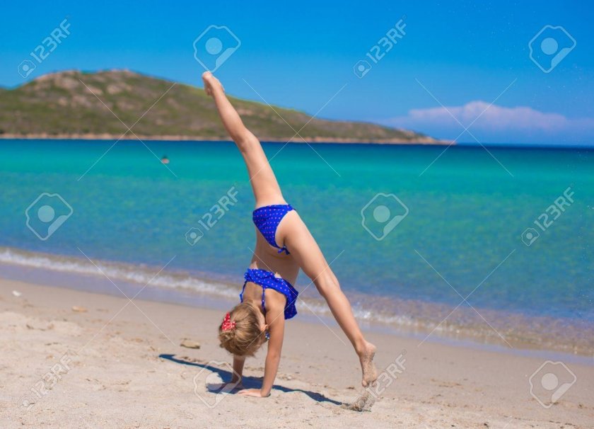 Little gymnast on the beach