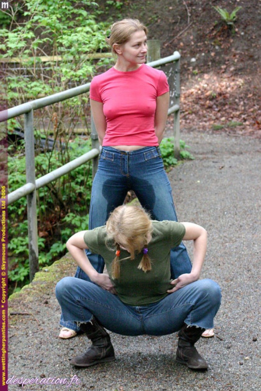 The girl makes pissing in jeans