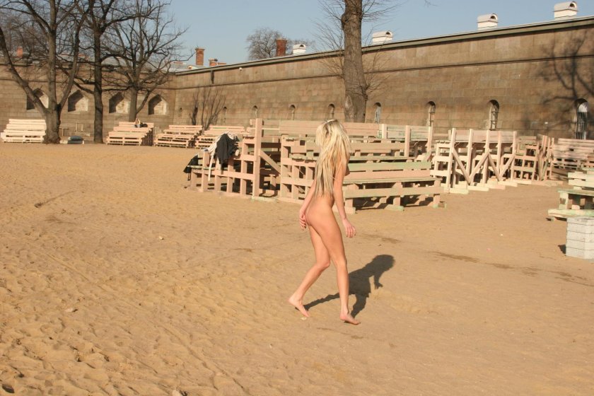 Naked woman runs along the street