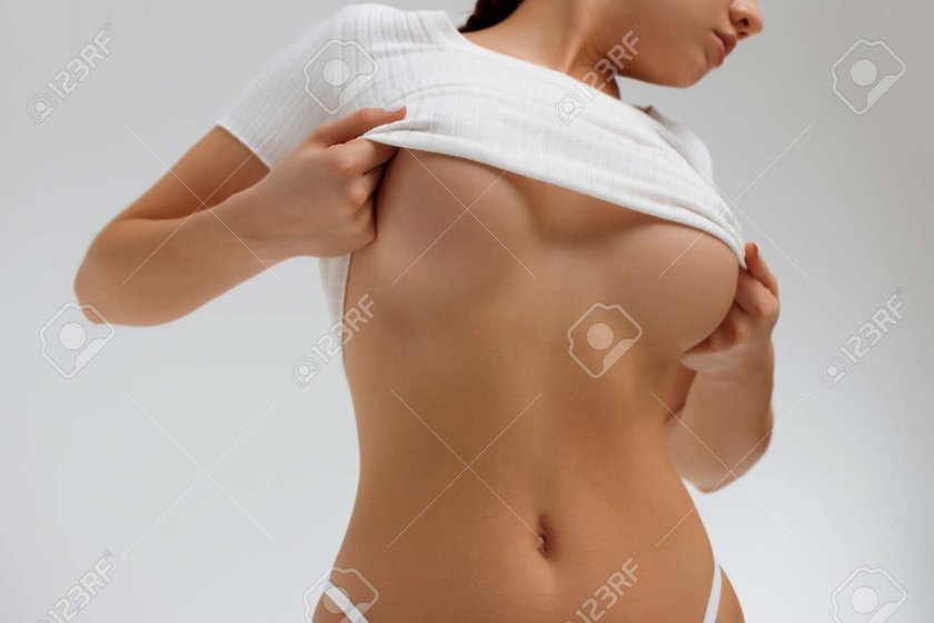 Woman takes off a T -shirt