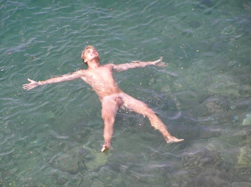 Boy naked on a river