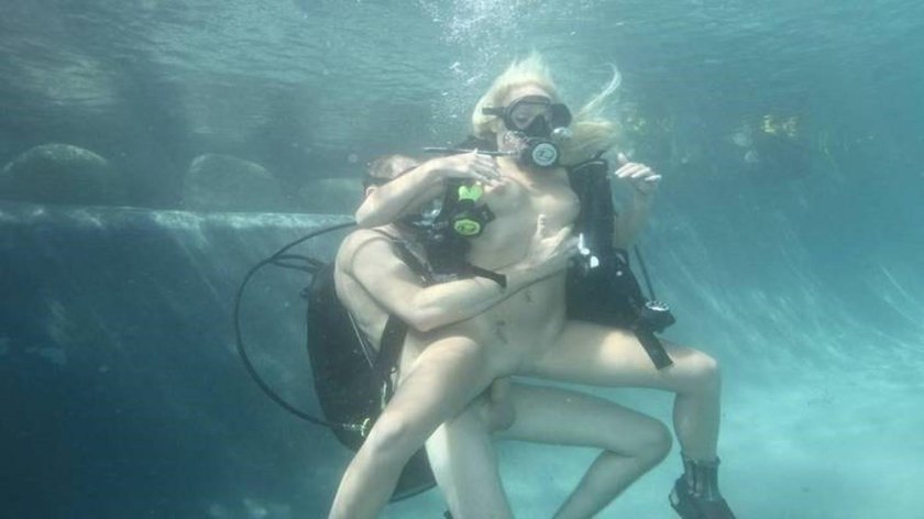 Naked women with scuba divers