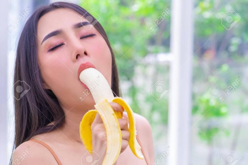 The girl licks banana