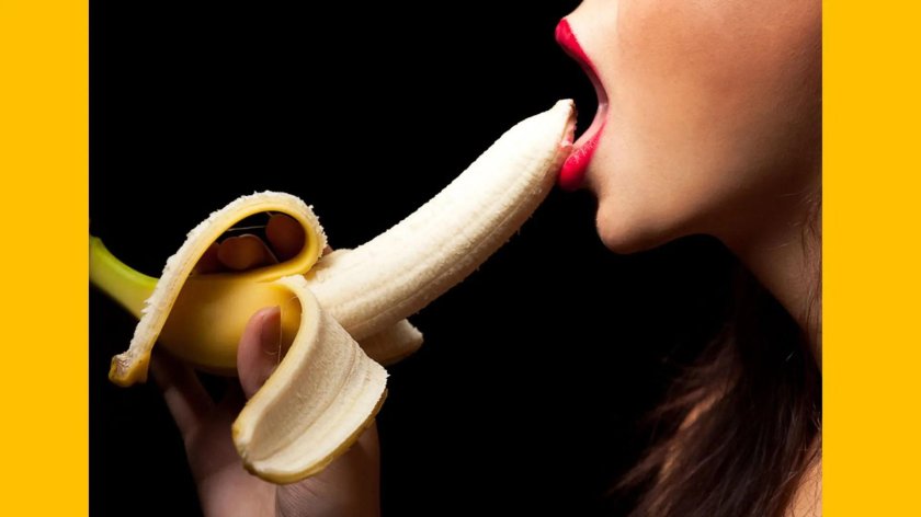 The girl licks banana