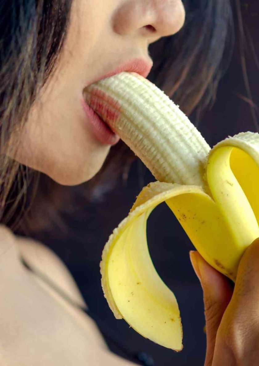 Girl with a banana in her mouth