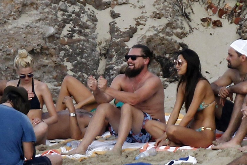 Leonardo di Caprio with models on the beach
