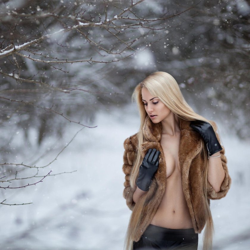 Beautiful girl in the snow an unbuttoned jacket
