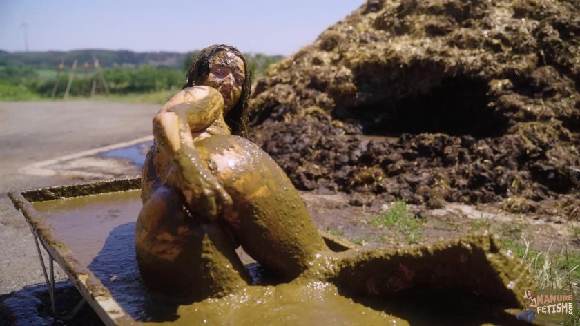Women swim in the mud