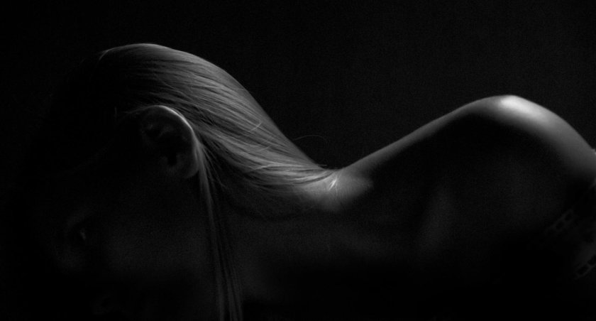 Female body on a dark background