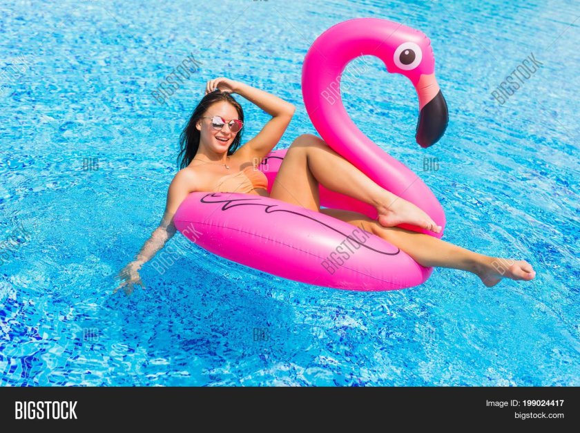 Girl in the pool on flamingos