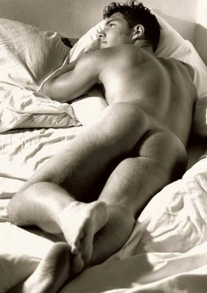 A handsome guy sleeps naked