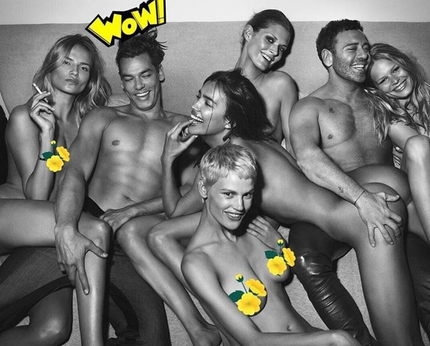 A guy surrounded by naked women