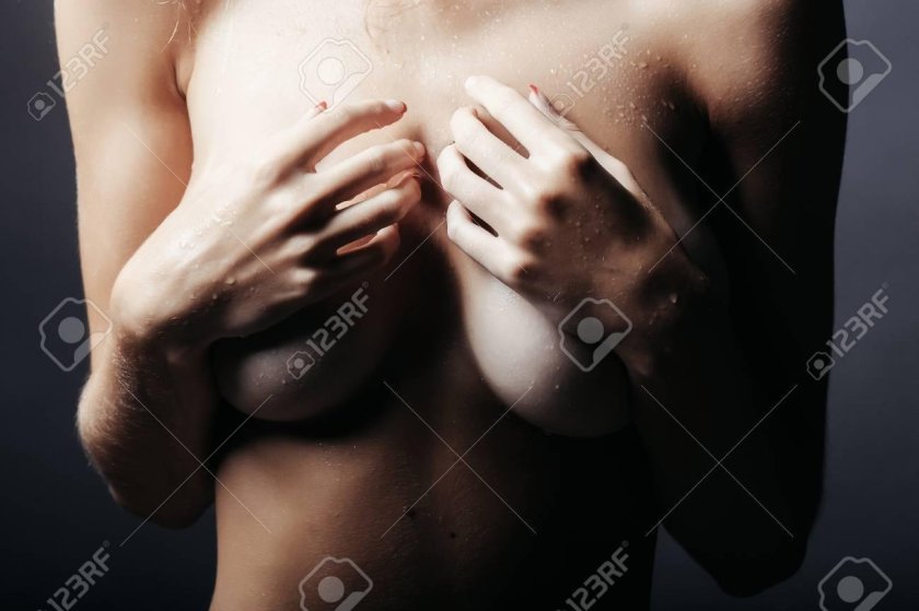 The girl covers her chest with hands