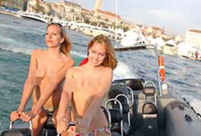 Blonde poses naked on a boat